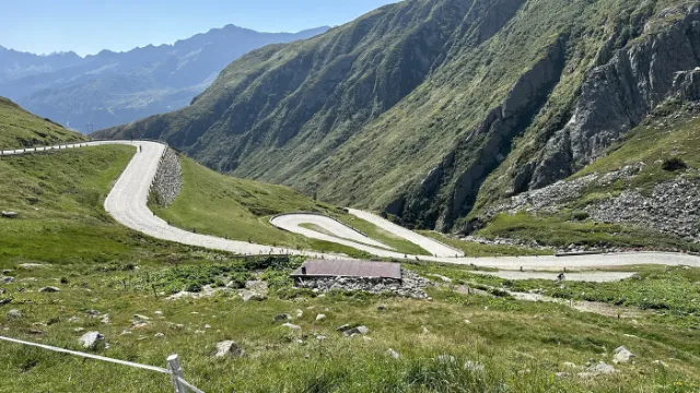 Eine Passstrasse mit Kehren, von oben gesehen.